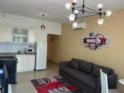 a living room with a couch and a kitchen at Quiet and beautiful view in Boca Chica