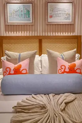 a bed with pillows with orange bears on it at Increíble ático de lujo con impresionantes vistas in Puerto Plata
