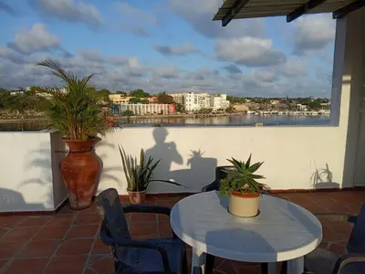 a patio with a table and potted plants on a balcony at Espacio Santa Bárbara, Zona Colonial in Santo Domingo