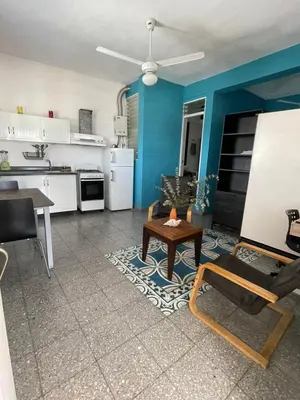 a living room with a table and a kitchen at Espacio Santa Bárbara, Zona Colonial in Santo Domingo