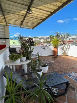 a patio with potted plants and a table and chairs at Espacio Santa Bárbara, Zona Colonial in Santo Domingo