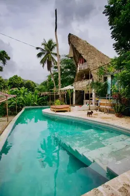 a swimming pool in front of a house at Ganesh Village Community in Colorado