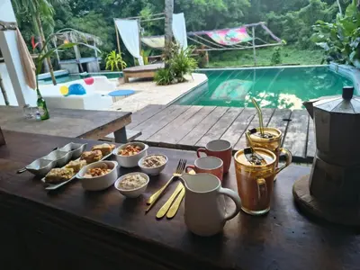 a table with food and drinks on a table near a pool at Ganesh Village Community in Colorado
