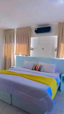 a bedroom with a large bed with colorful sheets at Zile Hotel in Boca Chica