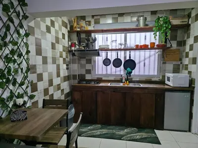 a kitchen with a sink and a table and a window at Playa y arena in San Felipe de Puerto Plata