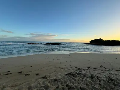 a beach with footprints in the sand and the ocean at Playa y arena in San Felipe de Puerto Plata