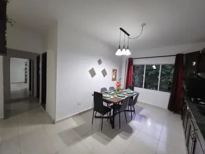 a dining room and kitchen with a table and chairs at Brisa de mar in San Felipe de Puerto Plata