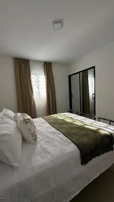 a bedroom with a large bed and a large mirror at Apartamento en La Romana 3 habitaciones in La Romana