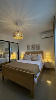 a bedroom with a large bed and a chandelier at Apartamento en La Romana 3 habitaciones in La Romana
