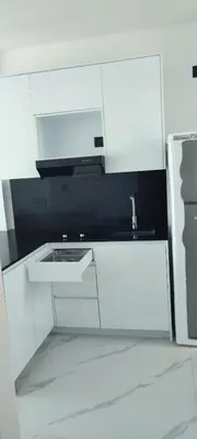 a white kitchen with a sink and a microwave at Penthouse in Cana Rock in Punta Cana