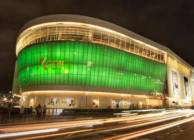 a large building with a green facade at night at Comfortable and quiet double room in Santo Domingo