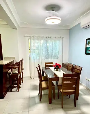 a dining room with a table and chairs at Sol Tropical apartamentos in Punta Cana