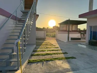 a backyard with a fence and stairs and grass at Terra Mia Villa in Pedernales