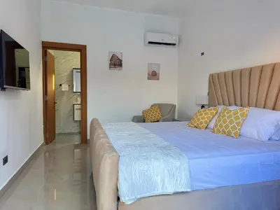 a bedroom with a large bed and a bathroom at Terra Mia Villa in Pedernales