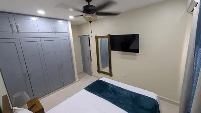 a bedroom with a bed and a mirror and a ceiling fan at Villa soñada 1 in Sosua