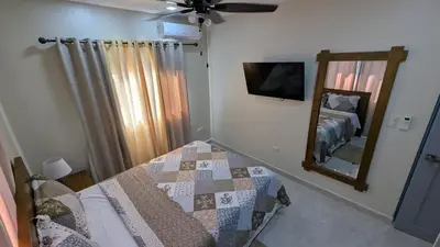 a bedroom with a bed and a mirror at Villa soñada 1 in Sosua