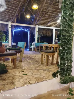 a patio with benches and tables in a room at Parador tropical in Las Galeras