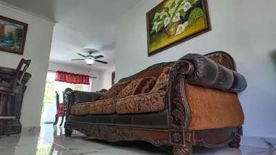 a large couch in a living room with a ceiling at Garden Mar in Bonao