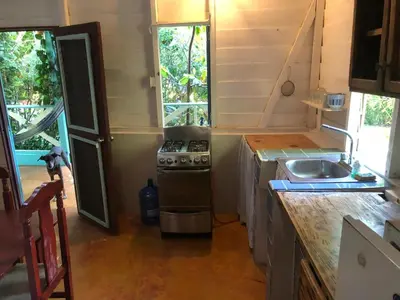 a small kitchen with a stove and a sink at Casa Ylang Ylang 1, Playa Encuentro in Cabarete