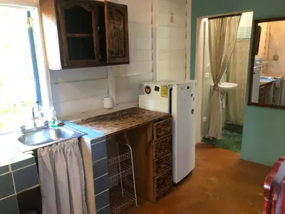 a kitchen with a white refrigerator and a sink at Casa Ylang Ylang 1, Playa Encuentro in Cabarete