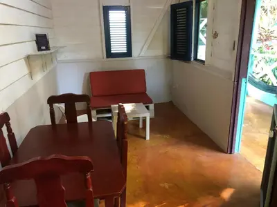 a room with a table and a chair and a table and a chair at Casa Ylang Ylang 1, Playa Encuentro in Cabarete