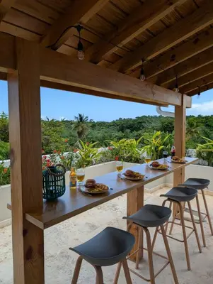 a table with food and drinks on a patio at Jardines de Montserrat - Lux, Rooftop, 3Bds, near beach in Las Terrenas