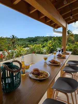 a table with food and drinks on a balcony at Jardines de Montserrat - Lux, Rooftop, 3Bds, near beach in Las Terrenas