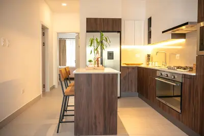 a kitchen with a island in the middle of a room at Modern & Cozy Luxury Suite with Amazing Views of STI in Santiago de los Caballeros