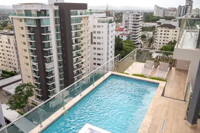 a swimming pool on the balcony of a building at Modern & Cozy Luxury Suite with Amazing Views of STI in Santiago de los Caballeros