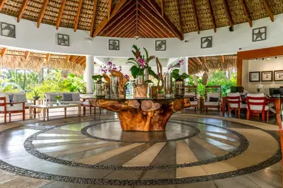 a lobby with a table in the middle of a room at Beachfront Sublime Las Terrenas in Las Terrenas