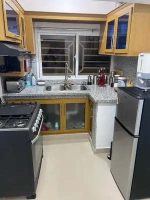 a kitchen with a sink and a stove at Casa amarilla in Cumayasa Kilómetros 4 1/2