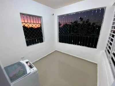 a room with two windows and a trash can at Casa amarilla in Cumayasa Kilómetros 4 1/2