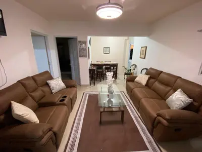 a living room with two brown couches and a table at Casa amarilla in Cumayasa Kilómetros 4 1/2