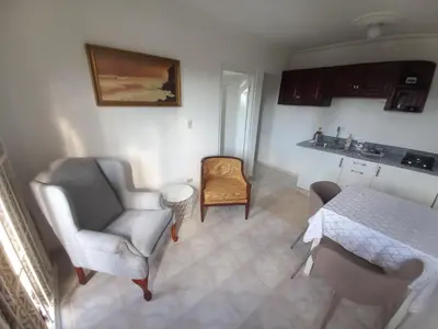 a living room with two chairs and a table at Casa Petter and Maria, 2end floor in Santiago de los Caballeros
