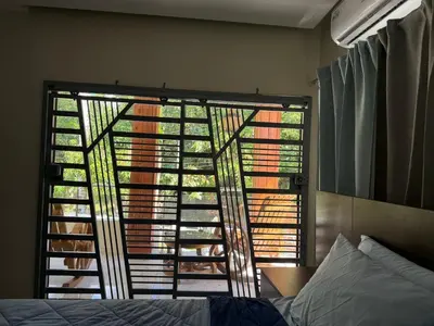 a bedroom with a window with a view of a tree at Villa Rafael in Bayaguana