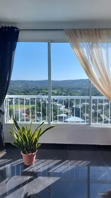 a room with a large window with a plant in front of it at Villa Maryluz in Alto de los Castillos