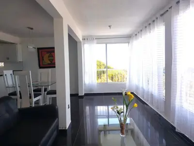 a living room with a couch and a window at Villa Maryluz in Alto de los Castillos