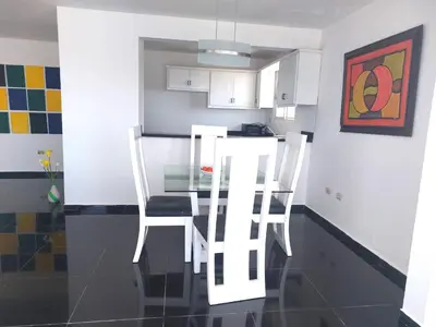 a kitchen with a glass table and two chairs at Villa Maryluz in Alto de los Castillos