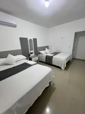 two beds in a room with two beds sidx sidx sidx at Hotel a 500 de la playa in Pedernales