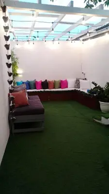 a living room with a couch in a room with grass at Hotel a 500 de la playa in Pedernales