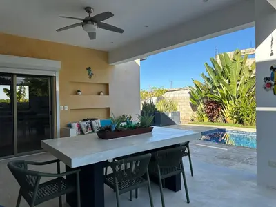 a dining table with chairs and a ceiling fan at Villa Olam - 9 pax, 4 min de la playa in Las Galeras