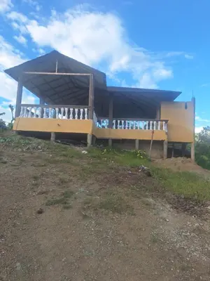 a building with a roof on top of a hill at Caribbean Corner in Jarabacoa