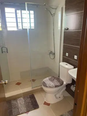 a bathroom with a shower and a toilet and a sink at Apartment in the heart of Santiago in Santiago de los Caballeros