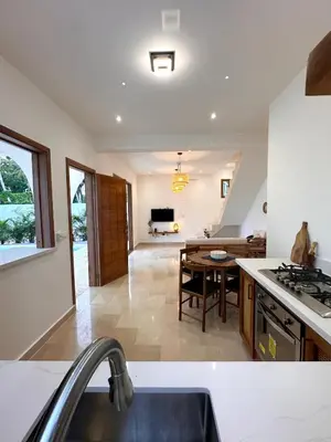 a kitchen with a table and a dining room at Villa Coral Blue in Playa Bonita in Las Terrenas