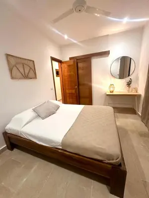 a bedroom with a bed and a mirror at Villa Coral Blue in Playa Bonita in Las Terrenas