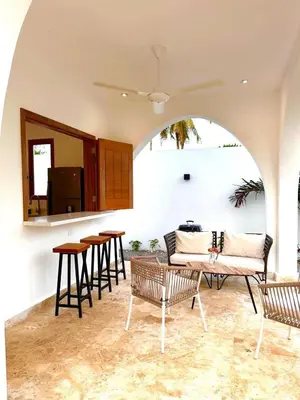 a living room with chairs and a couch and tables at Villa Coral Blue in Playa Bonita in Las Terrenas