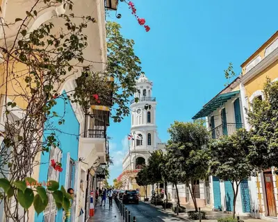 a city street with a clock tower in the background at Colonial Home with Private Terrace and Jacuzzi in Santo Domingo