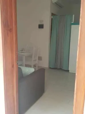 a mirror reflection of a living room with a table at Private studio apartment with eat in kitchen in Bayahibe