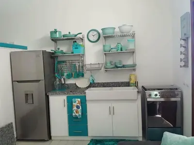 a small kitchen with a refrigerator and a stove at Private studio apartment with eat in kitchen in Bayahibe