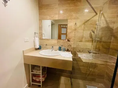a bathroom with a sink and a shower at Modern 2 Queen Beds Apartment with Garden View in Puerto Plata